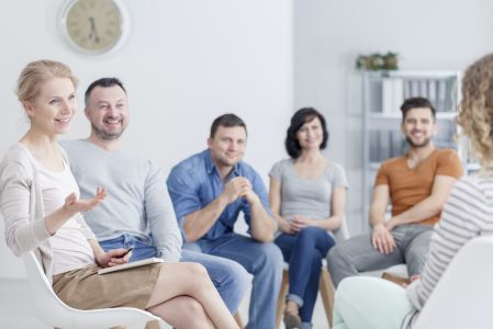 Group listening to the woman during psychotherapy session